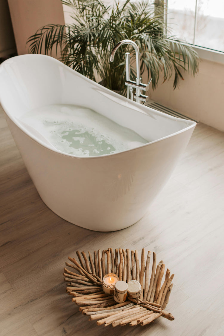 bath-tub-filled-with-bubbly-water-and-a-burning-candle-on-the-floor